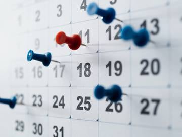 Pushpins on a calendar.